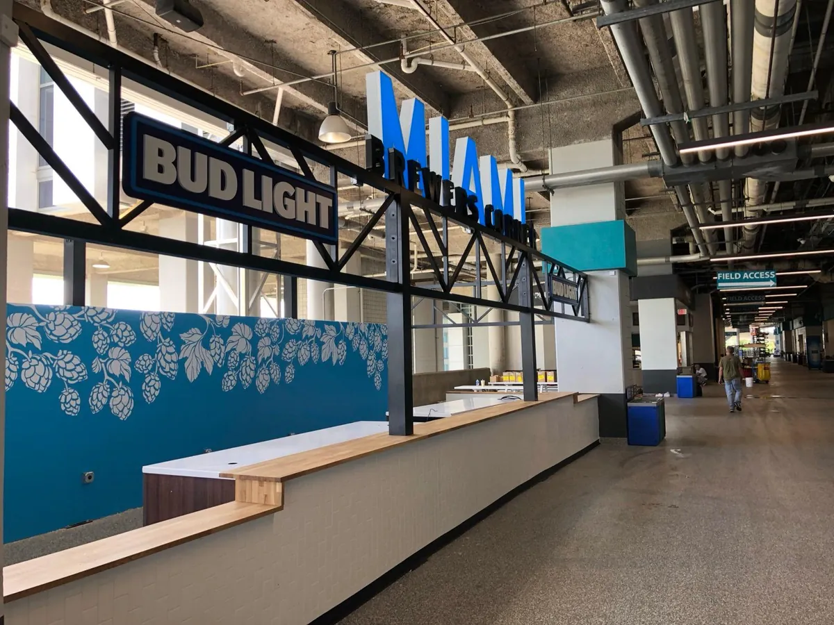 Custom dimensional signage and wall graphics at a Miami stadium concourse